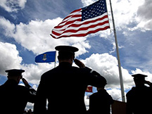 Soldiers saluting the flag