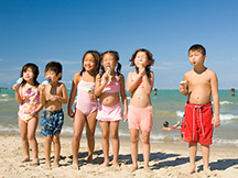 Children at the beach with ice cream